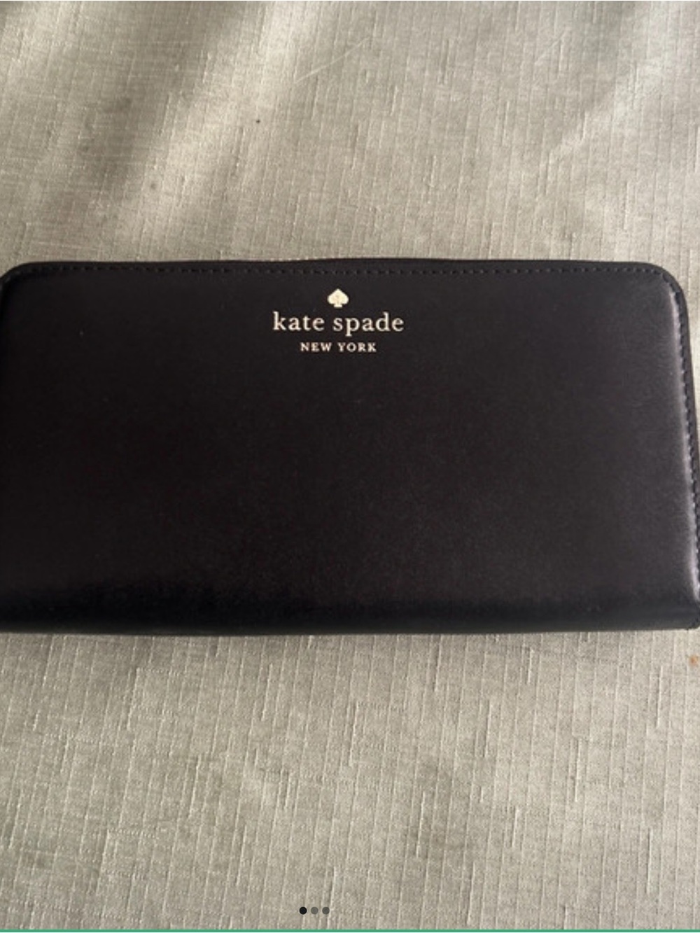 “New With Tags” kate spade black zip-around continental wallet with gold logo.